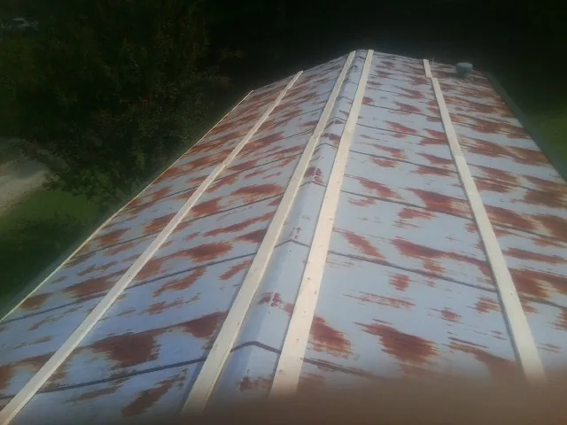 Rusted metal roof panels with new wood purlins before replacement — Storm Damage Roof Repair in Sebring by Roofing Brothers